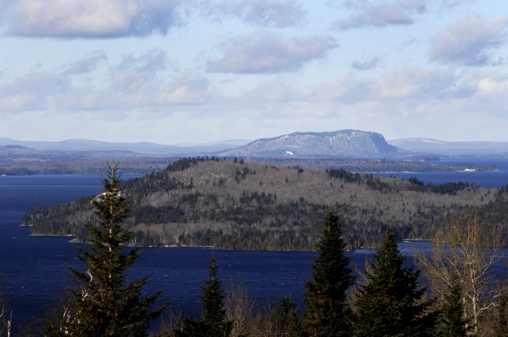 Moosehead Lake's iconic Mount Kineo rises over the lake. The Moosehead Region Futures Committee is expressing concern that energy company SunEdison might file for bankruptcy and says it is committed to defeating plans the company has to build a 26-turbine wind farm in Misery Ridge.