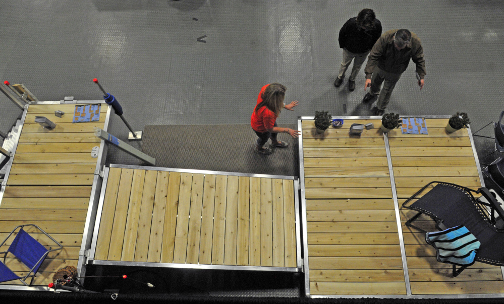 Sara Lacharite, of Pleasant Dock Systems, left, talks to customers Friday during the 43rd annual Manchester Lions Club Home and Garden Show at the Augusta Civic Center.