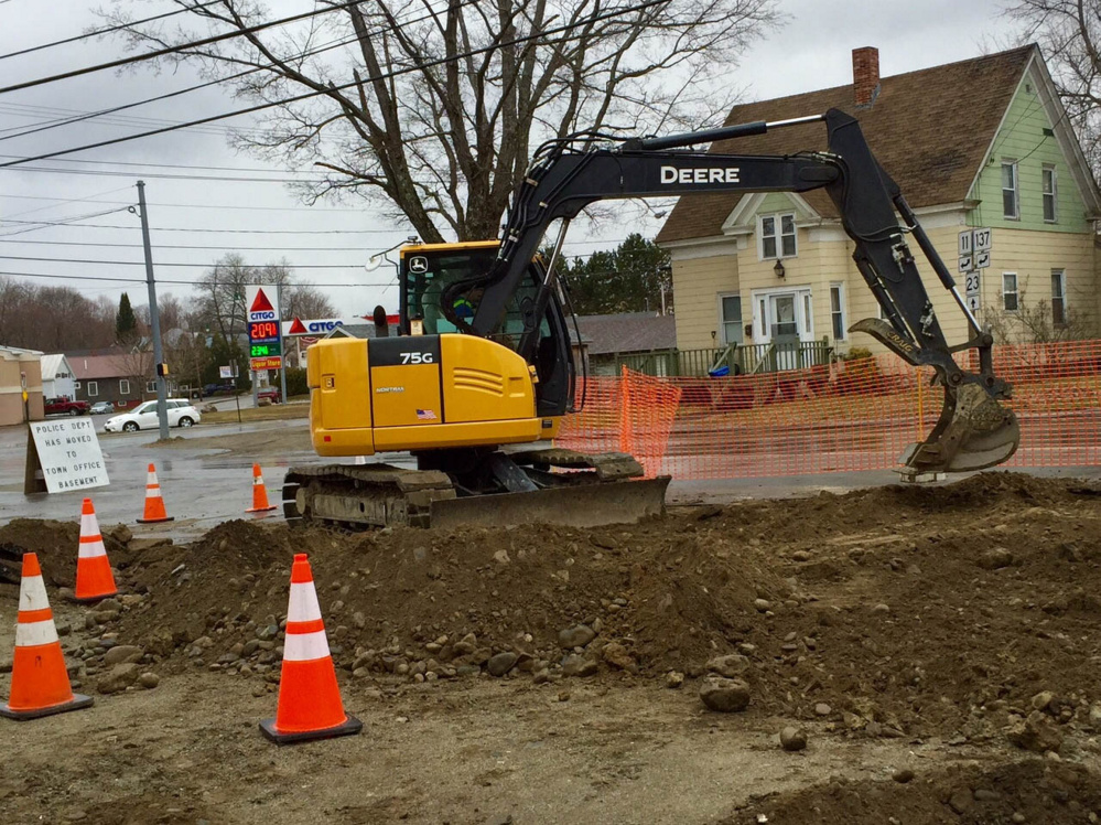An excavator digs on Monday morning at the site of a new Oakland Police Department building that is under construction and scheduled to be finished in August.