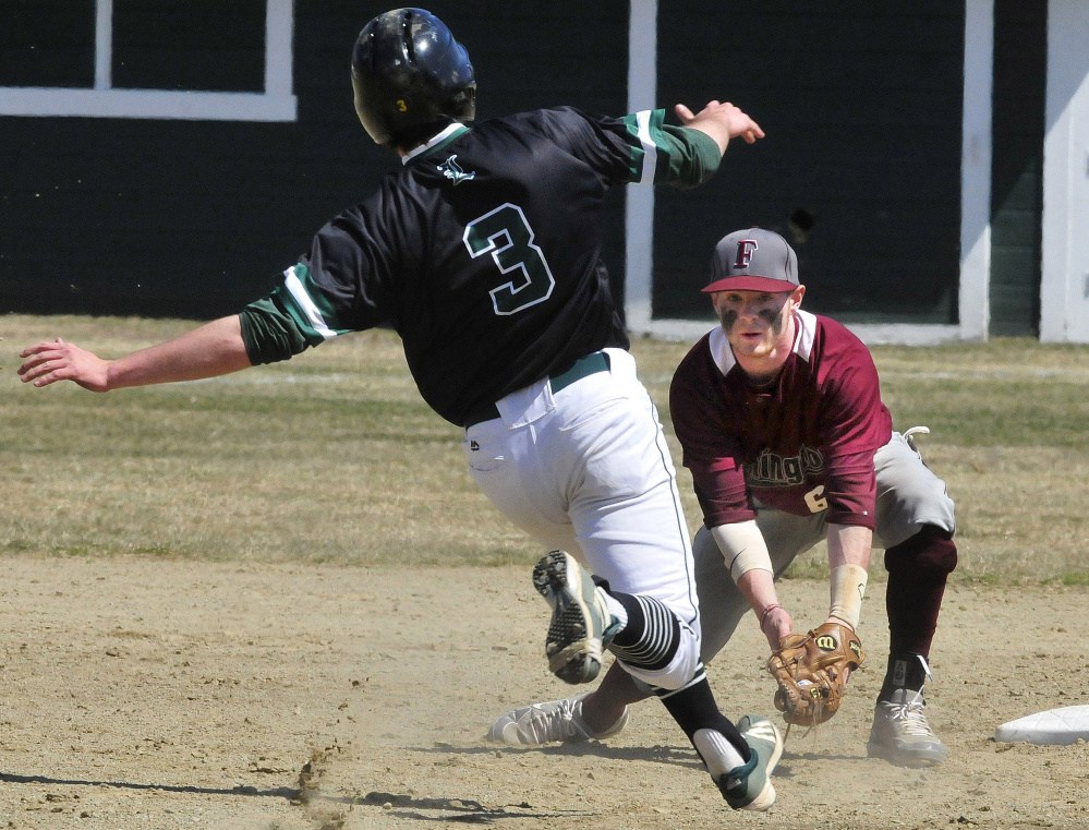 University of Maine at Farmington's Trevor Hisler waits to tag out Lyndon State's Ian Machia (3) on Sunday in Farmington.