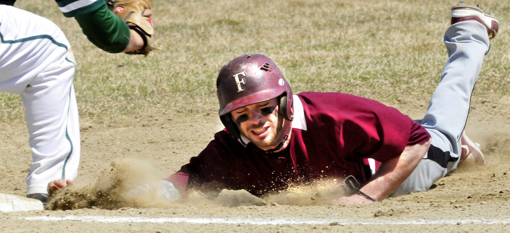 University of Maine at Farmington's Grayson Beressi makes it back to first base in time during a game against Lyndon State on Sunday in Farmington.