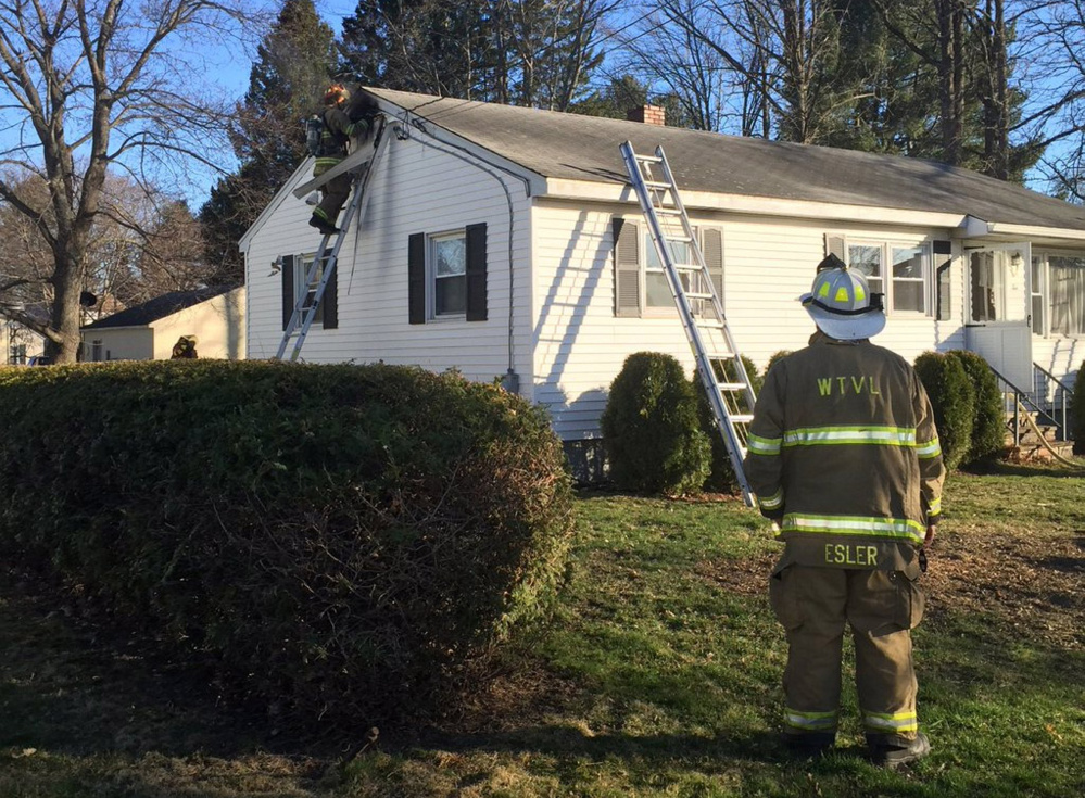 Waterville firefighters tackle a house fire on Oakdale Street Thursday night. It was the second house fire in the city Thursday.