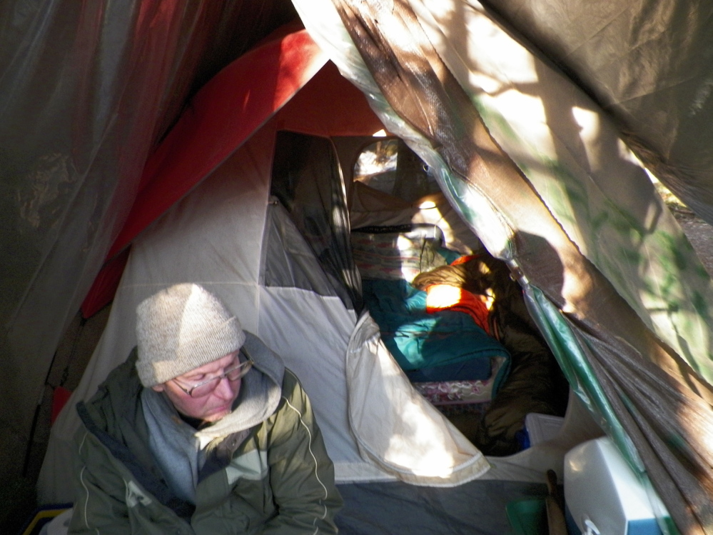 Christopher Knight sits in April 2013 at his camp in this photo taken by Maine State Police.