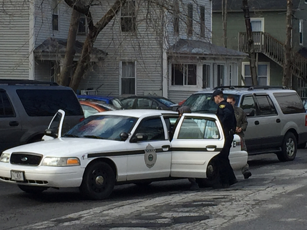 Augusta police and Maine Drug Enforcement Agency officials arrest Charles Evans, of Rochester, N.Y., on charges of drug trafficking Tuesday afternoon on Middle Street in Augusta.