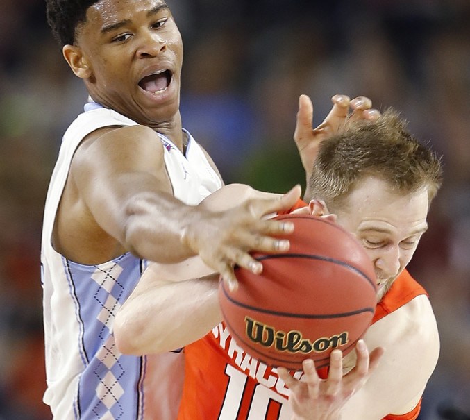 North Carolina guard Nate Britt defends against Syracuse guard Trevor Cooney (10) Saturday in Houston. (AP Photo/David J. Phillip)