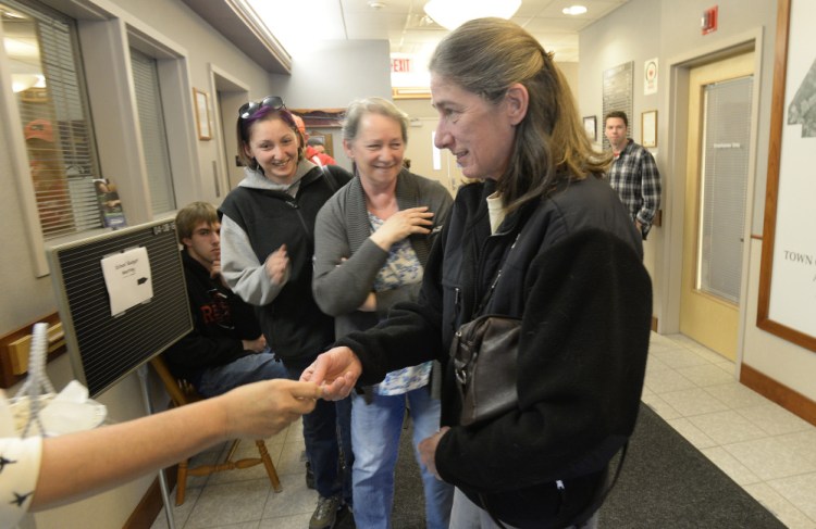 Nancy Rodoalph, right, won Scarborough's lottery Friday for a coveted commercial shellfish license.