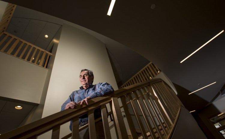 Coastal Enterprises Inc. and Ron Phillips, at work in his Brunswick office, have provided nearly $1.2 billion in financing to more than 2,500 small businesses, and created or preserved thousands of jobs, affordable housing units and child care slots.