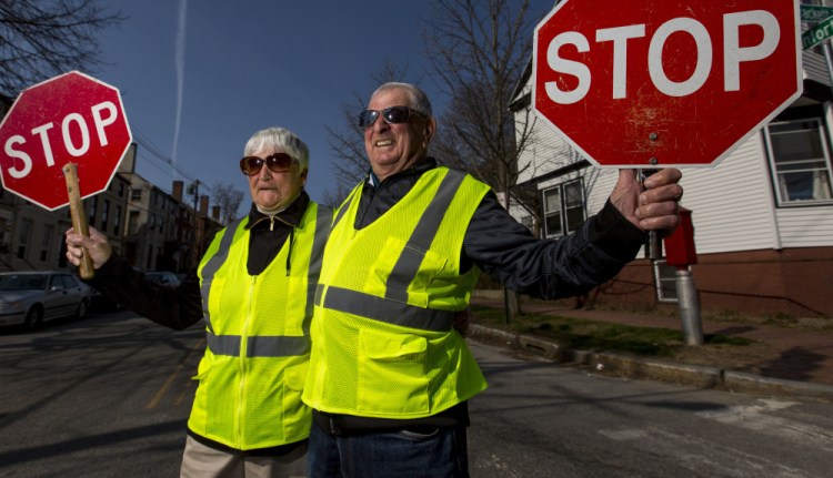 Marion and Lou Alexander stand at Lou's usual post – the corner of Brackett and Danforth streets. Marion works a block away at Danforth and Clark.