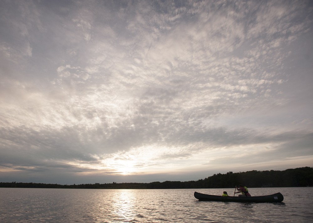 Ruth Bagless of Bangor and her daughter, Frances, paddle across the water on Fields Pond to explore birds and nature as part of the Maine Audubon's evening paddle. Fields Pond is one of the eight Audubon centers in the state.