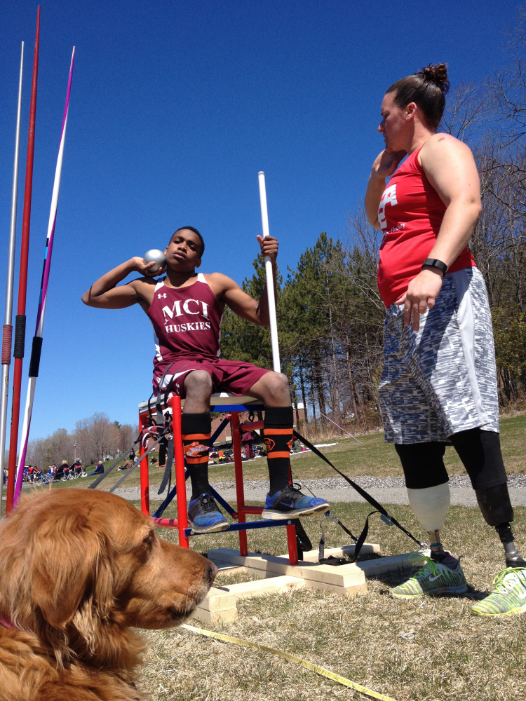 Christy Gardner, right, gives some advice to Maine Central Institute's ZyAnthony Moss as her service dog, Moxie, looks on Saturday at MCI in Pittsfield.