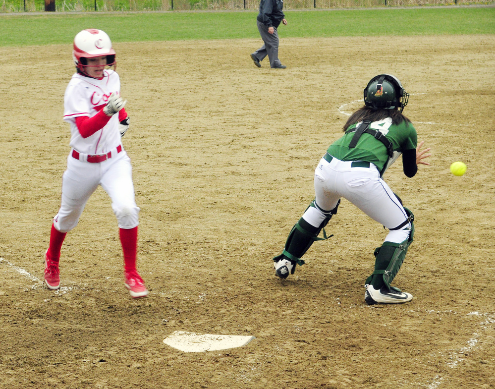 Carrie Meehan, left, beats the throw to Oxford Hills catcher Anna Piirainen to score on a double by teammate Haley Wood during a Kennebec Valley Athletic Conference Class A game Wednesday at Cony Family Field in Augusta.