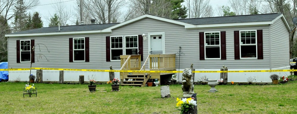 Police tape surrounds a mobile home at 3 Alley Lane in Troy after fire did serious damage to the interior Wednesday night.