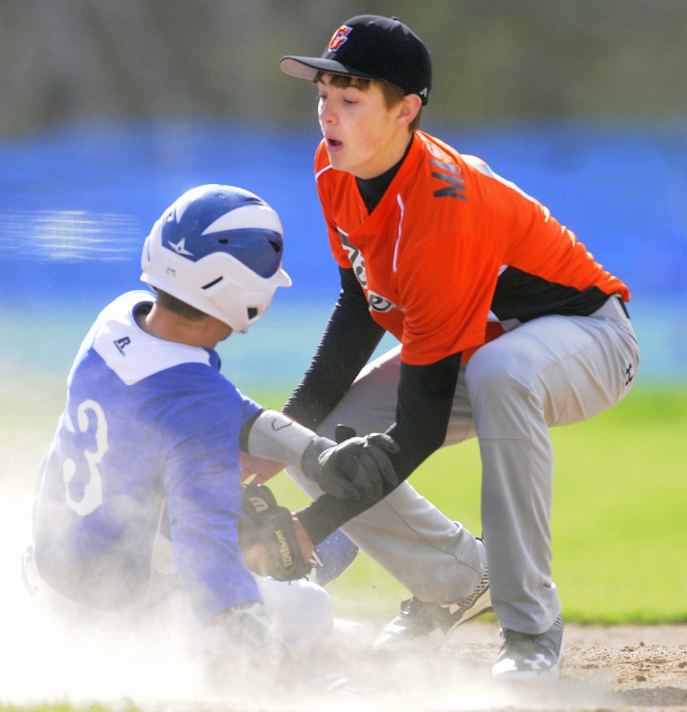 Erskine's Jake Suga gets tagged out at second by Gardiner infielder Devon Maschino during a Kennebec Valley Athletic Conference Class B game Monday afternoon in South China.