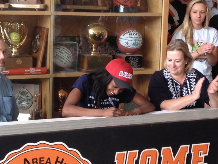 Skowhegan senior Maddy Price signs her letter of intent to attend Farleigh Dickinson during a ceremony at the high school Monday afternoon. Price will compte on the track and the field team for the division I school in Teaneck, New Jersey.
