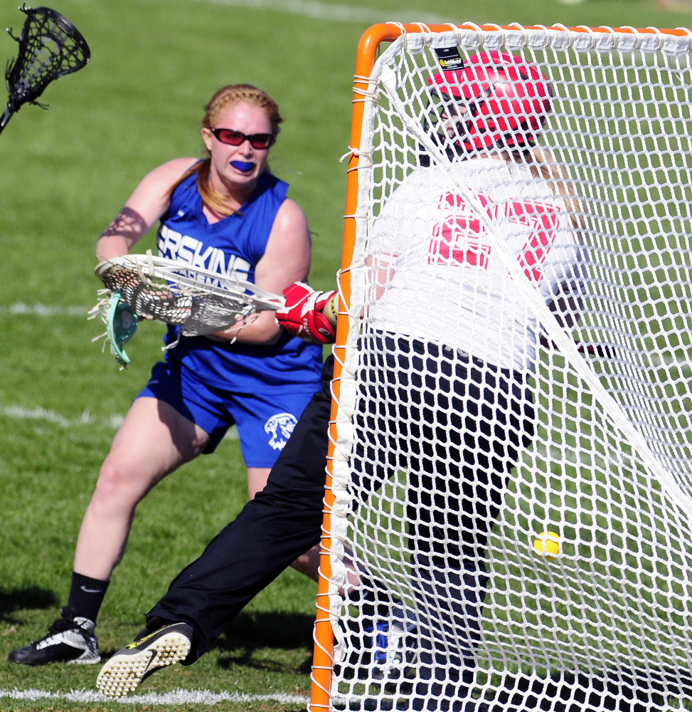 Erskine's Kaitlyn Darveau shoots and scores on Cony keeper Lizzy Dennison to make it 5-1 in first half Tuesday in Augusta.