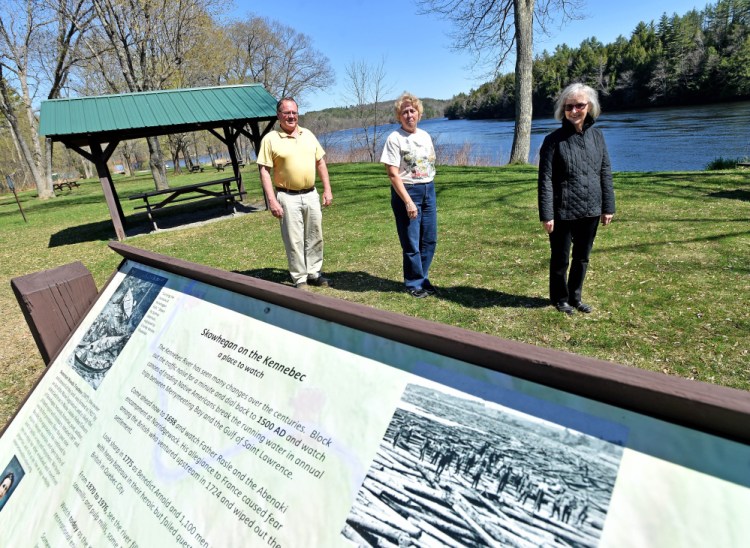 Gregory Dore, left, treasurer of the Somerset Woods Trustees, stands with Debra Burnham, center, and Jeanne Shay, right, both with the Bloomfield Garden Club, on Wednesday at the Great Eddy of the Kennebec River on U.S. Route 2 in Skowhegan. The garden club wants to replace the Blue Star Memorial Highway marker that was swept away in the 1987 flood.