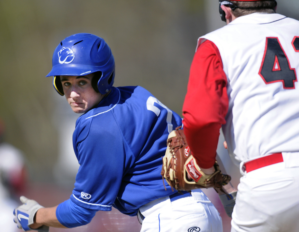 Hall-Dale's Cole Lockhart, right, chases Madison's Sean Whalen between first and second base Wednesday in Farmingdale. Lockhart made the tag.