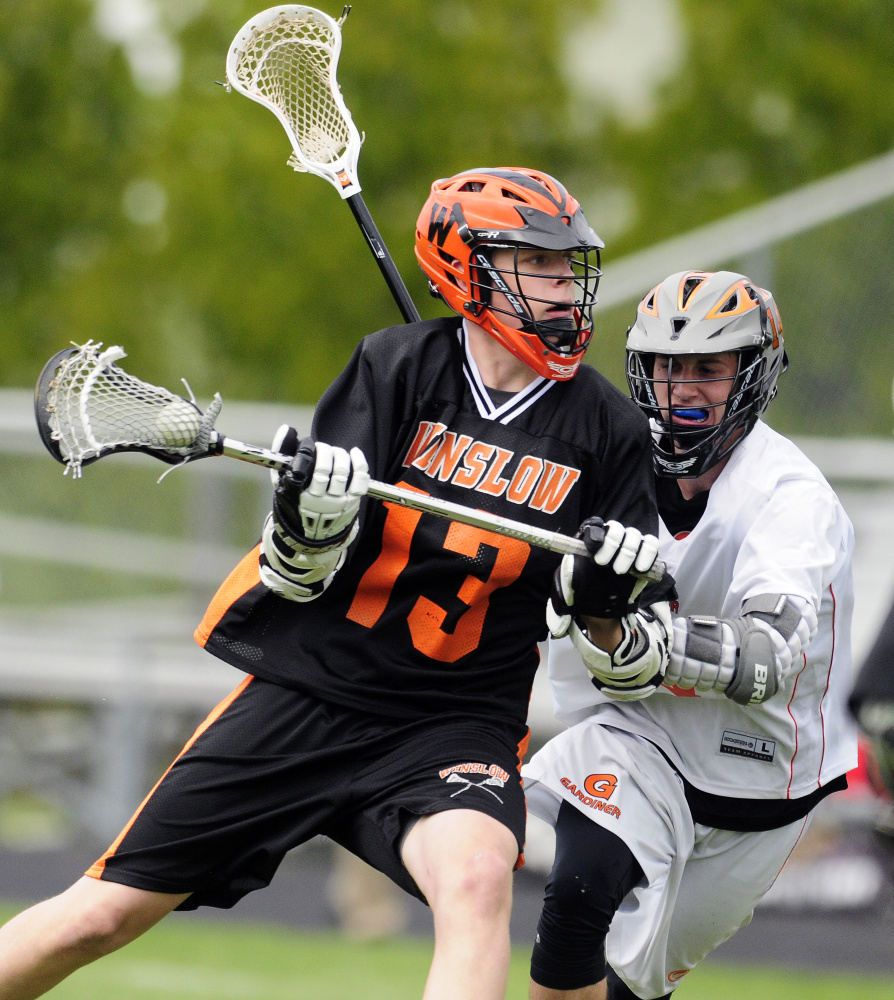 Winslow's David Selwood tries to get past the defense of Gardiner's Matt Boynton during a game Thursday in Gardiner.