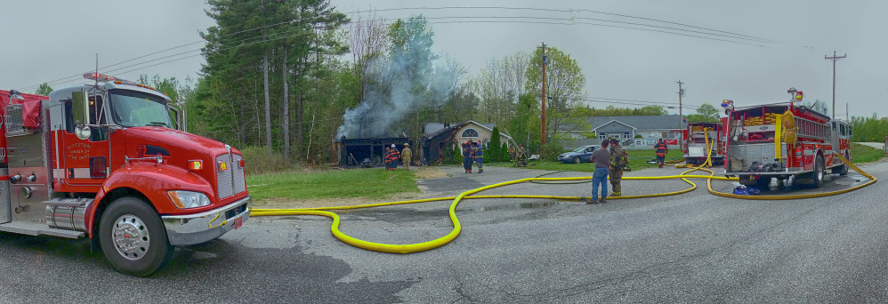 Firefighters from several departments work to put out a house fire Saturday on Pushard Lane in Gardiner.