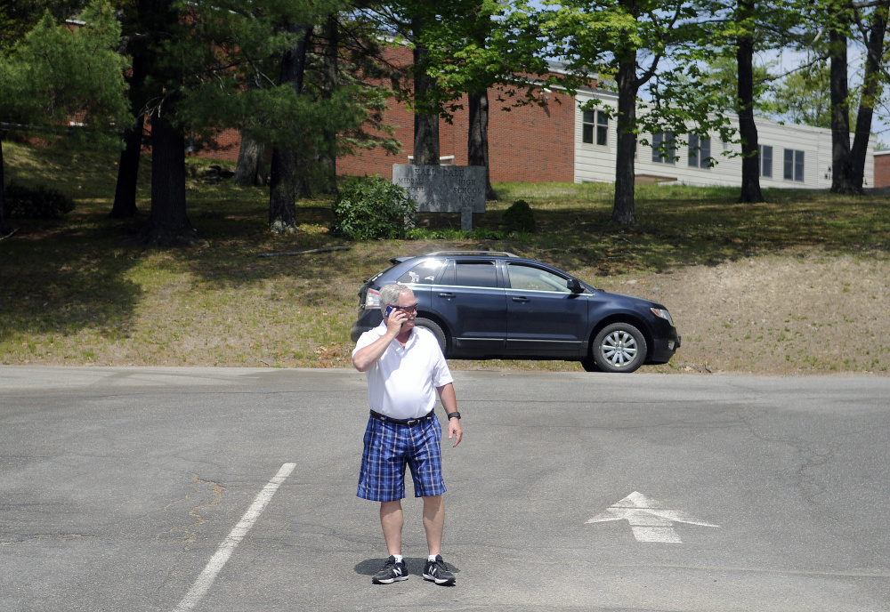 Hall-Dale High School Athletic Director Colin Roy blocks traffic at the Farmingdale school on Monday as police search the school following a bomb threat.