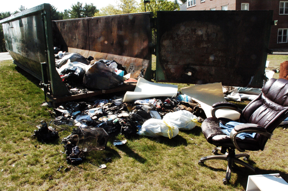 Furniture and other items are shown that were burned last weekend damaging a dumpster outside the Alfond dormitory on the Colby College campus in Waterville.