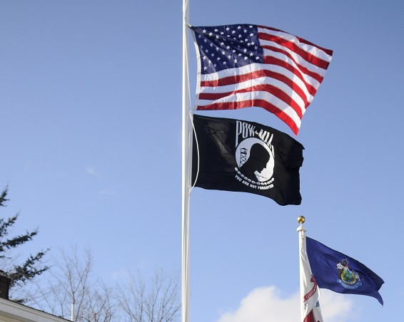 Veterans raise the colors in 2014 on the new flag poles that were dedicated at the Bread of Life Ministries Veterans Shelter in Augusta in this file photo.