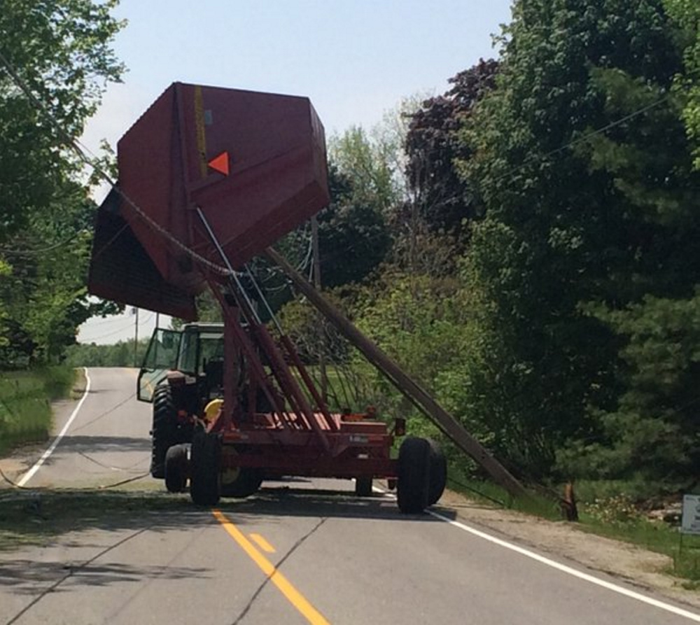 A tractor struck a utility pole on Main Street in Monmouth about 11 a.m. Wednesday, knocking out power to more than 900 people in town.