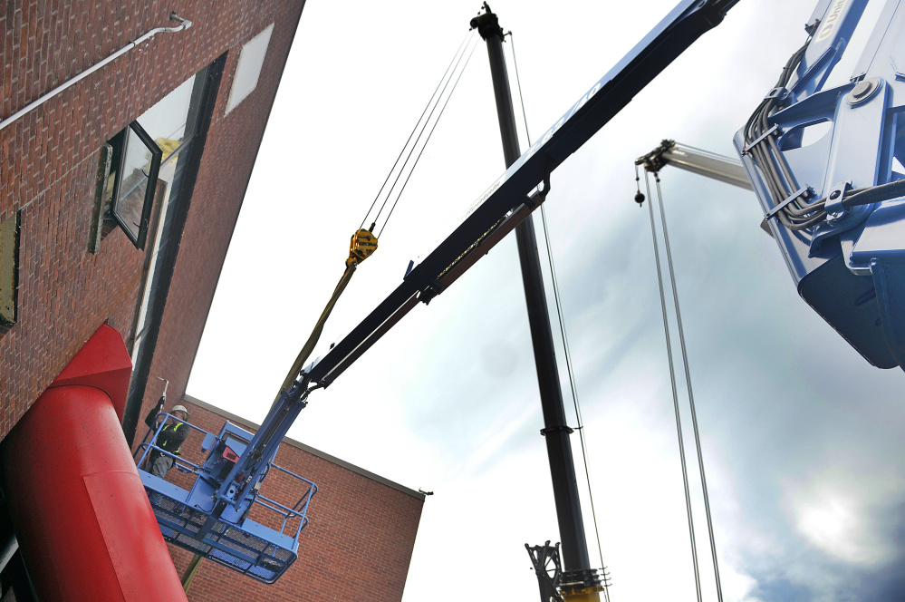 Workers cut a pump Wednesday at the Gardiner Wastewater Treatment Plant, where a new screw pump is being installed.
