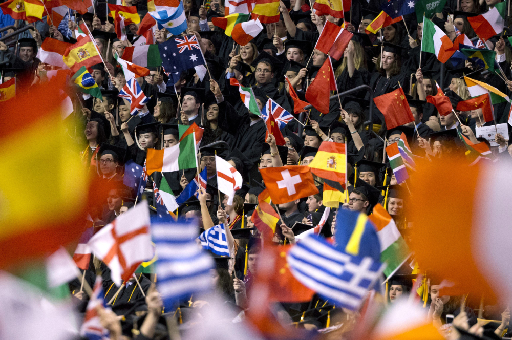 Graduating students wave national flags during Northeastern University's commencement Friday. Secretary of State John Kerry told the graduating class that their diversity makes them "Donald Trump's worst nightmare."