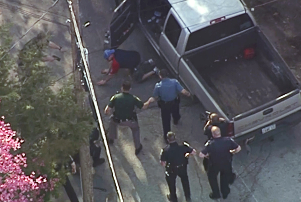 Images made from a helicopter video provided by WHDH in Boston showed Richard Simone putting his hands on the ground after a high-speed chase that ended in Nashua, N.H. Moments later officers rushed Simone and pummeled him.