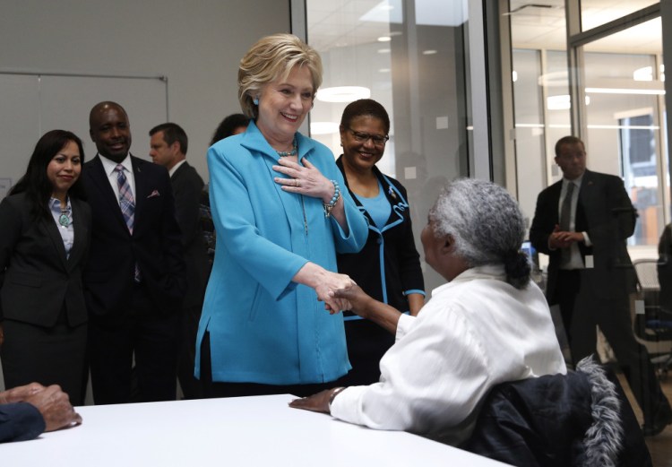 Democratic presidential candidate Hillary Clinton greets people as she tours the Community Coalition on Tuesday in Los Angeles, Calif.