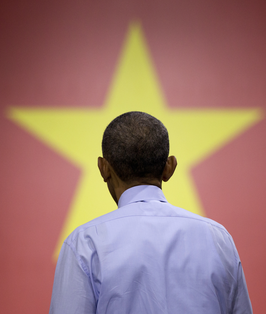 President Barack Obama turns to listen to a question from the audience as he speaks to Vietnamese young people during the Young Southeast Asian Leaders Initiative (YSEALI) town hall-style event at the GEM Center in Ho Chi Minh City, Vietnam, Wednesday.