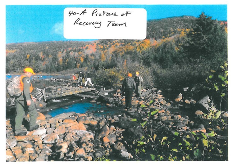 Members of the recovery team that brought Geraldine Largay's remains and effects out of the remote woods walk past a body of water near the mountains of Franklin County. Doug Dolan of the Maine Appalachian Trail Club says, "Maine has some of the most rugged terrain on the Appalachian Trail."