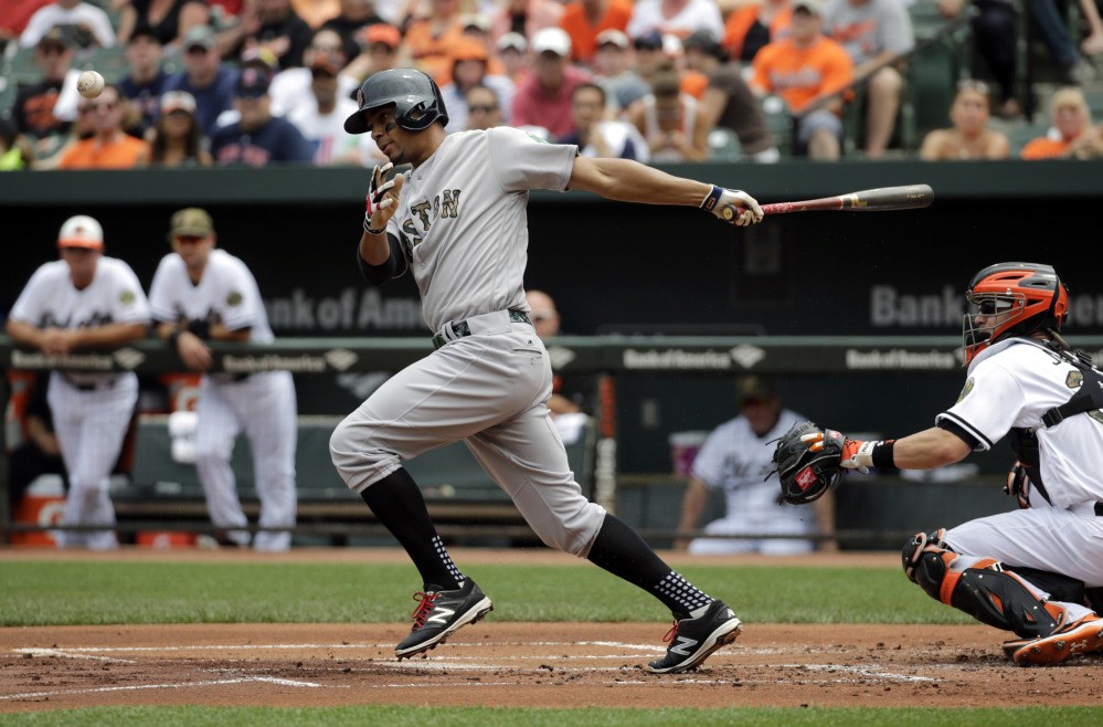 Red Sox shortstop Xander Bogaerts hits a chopper in front of the plate in the first inning Monday in Baltimore. Bogaerts, who later extended his hitting streak to 23 games, was thrown out at first on the play, but Mookie Betts scored from second base. The Red Sox beat the Orioles 7-2.
