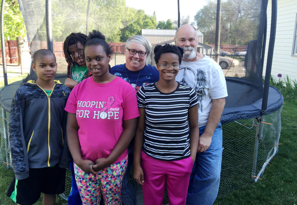 Shelly and Tim McDaniel, back row, right, are seen with some of their adopted children. The family contains almost the entire black population of Dietrich, Idaho.