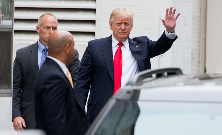 Republican presidential candidate Donald Trump waves as he arrives for a meeting with House Speaker Paul Ryan at the Republican National Committee Headquarters on Capitol Hill Thursday. The Associated Press