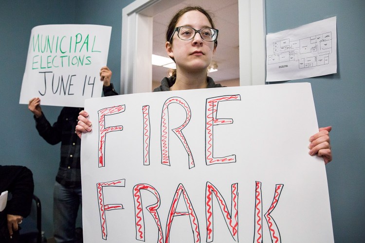 Victoria Hugo-Vidal of Buxton holds a protest sign during a SAD 6 school board meeting Monday. Last week, the board determined that Frank Sherburne had violated the district's nepotism policy by hiring his son for an ed tech position, but the board did not take any action against Sherburne. 