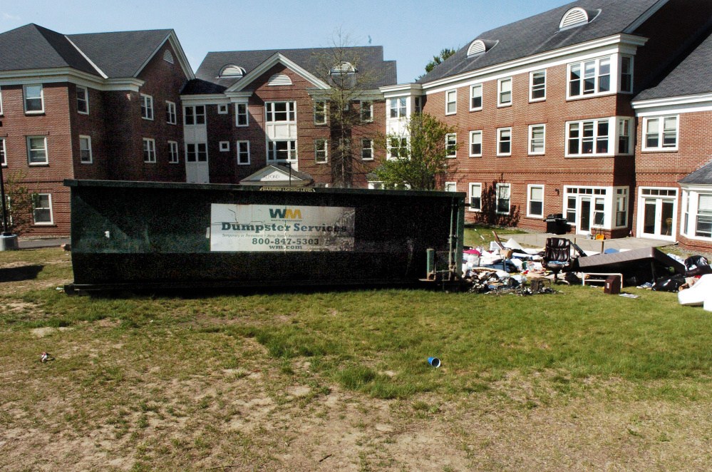 A charred dumpster stands loaded with items from Colby College students outside the Alfond dormitory after a May 22 fire that may result in arson charges. The Kennebec County district attorney is reviewing the case, Waterville and state fire officials said Wedneday.