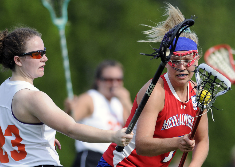 Gardiner's Evelyn Hinkley, left, blocks Messalonskee's Lydia Dexter during a lacrosse game Wednesday in Gardiner.