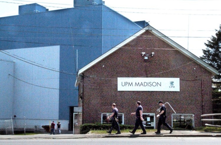Workers carry tools into the Madison Paper Industries mill in Madison on May 23, the last day of production at the mill. The town recently was given a good credit rating even though the mill, its biggest taxpayer, had closed.