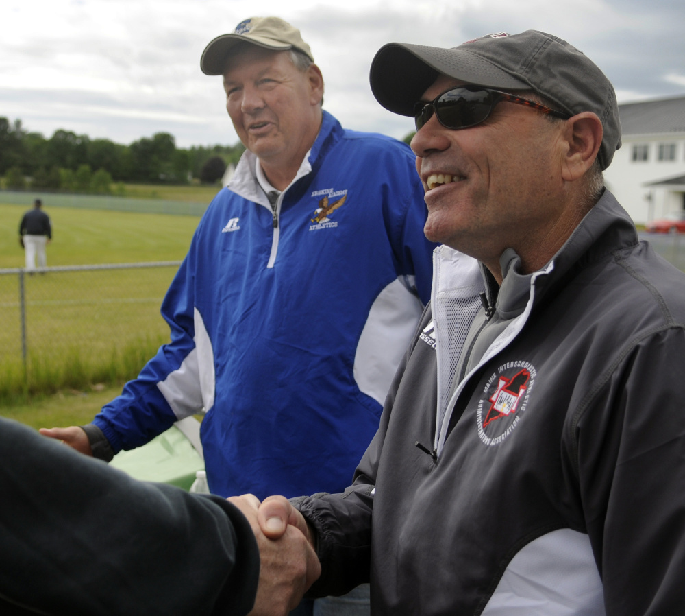 Erskine Academy athletic director Doran Stout, left, introduces his replacement, Chuck Karter, during a baseball game Thursday in South China. Stout is retiring after 22 years as the school's athletic director.