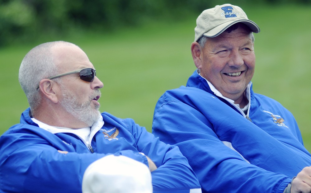 Erskine Academy assistant baseball coach Scott Corey, left, speaks with athletic director Doran Stout during a baseball game Thursday in South China.