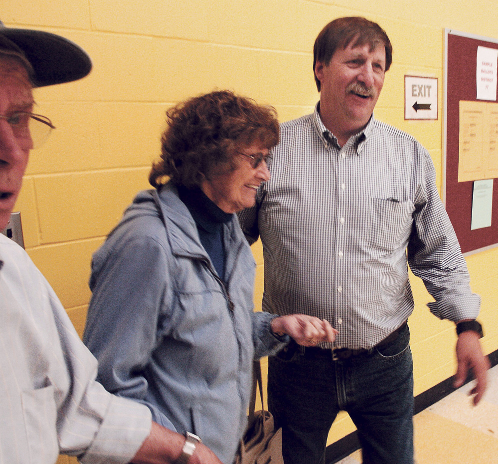 District 77 Republican candidate Mike Perkins leads voters to the voting booths Tuesday in Oakland. Perkins, of Oakland, was running against Kelly Couture, of Sidney.