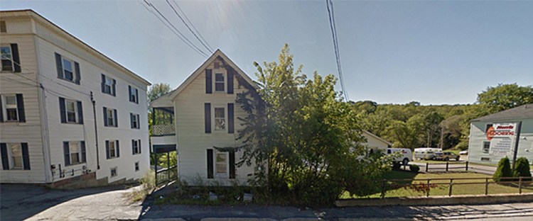 The house at 58 Mount Vernon Ave. in Augusta, the building in the middle of this photo, was torn down May 13 after city code enforcement officers and an engineer deemed it unsafe.