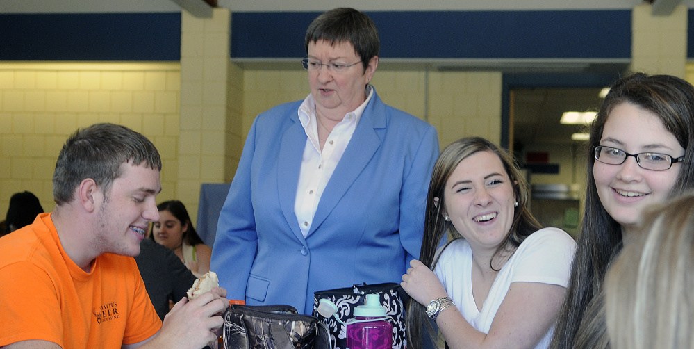 Oak Hill High School Principal Patricia Doyle speaks with students Wednesday in the cafeteria of the Wales school. Doyle is departing the school after 37 years.