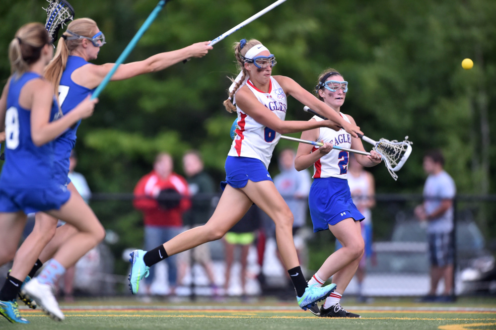 Messalonskee's Ally Turner, middle, scores a goal during the Class A North title game against Lewiston on Wednesday night at Thomas College in Waterville.