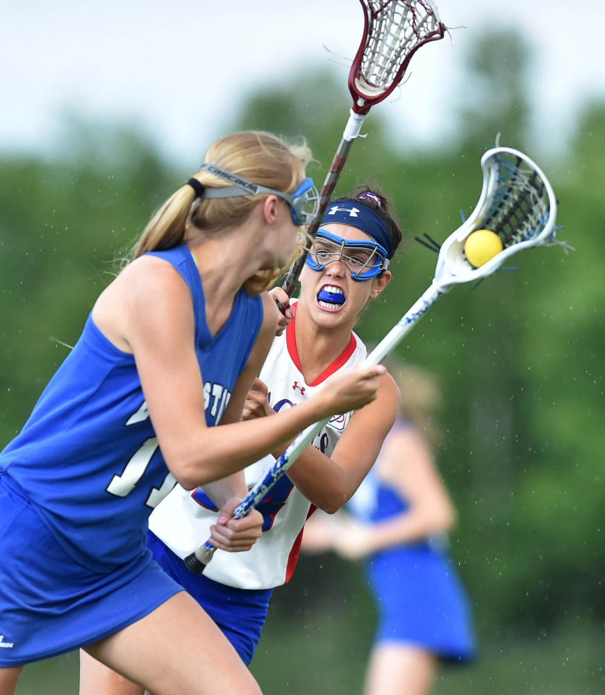 Messalonskee's India Languet, right, defends Lewiston's Morgan Eliasen during the Class A North title game Wednesday night at Thomas College in Waterville.