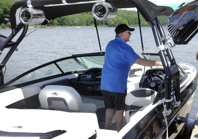 Kurt Gagnon pilots a boat at the docks on Maranacook Lake in Winthrop on Sunday. Gagnon's business, Gagnon Boats and Motors of Livermore Falls, offered fathers a boat ride in exchange for a donation to the P.A.L.S. Cat Shelter in Winthrop.