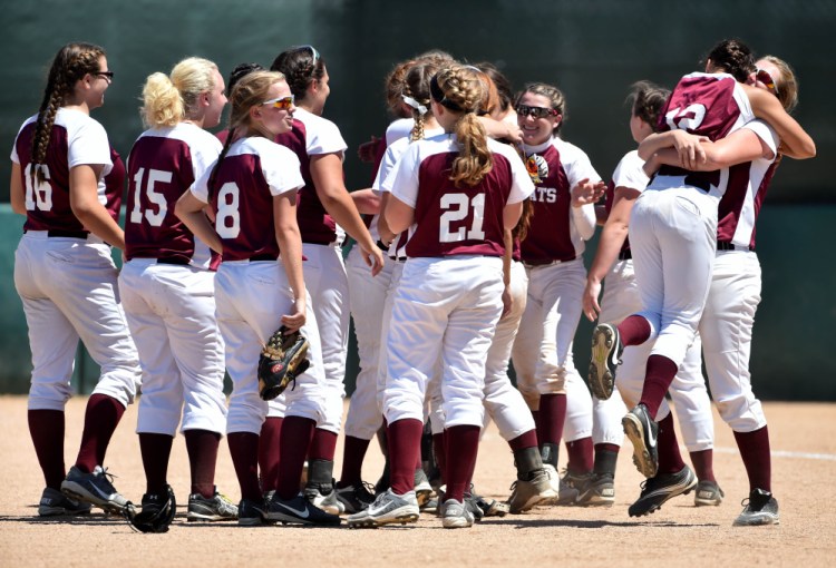 Richmond junior Mackenzie Abbott, far right, jumps into the arms of teammate Kelsea Anair after the Bobcats defeated Stearns 15-6 to win the Class D state championship at Coffin Field in Brewer on Saturday.