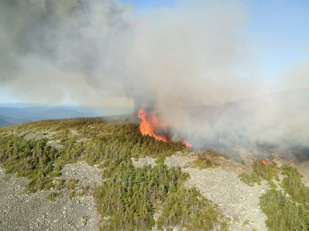 A fire burns last weekend at the summit of Mount Abraham, in Franklin County. An inch of rain overnight Wednesday and into Thursday has assisted firefighting efforts.
